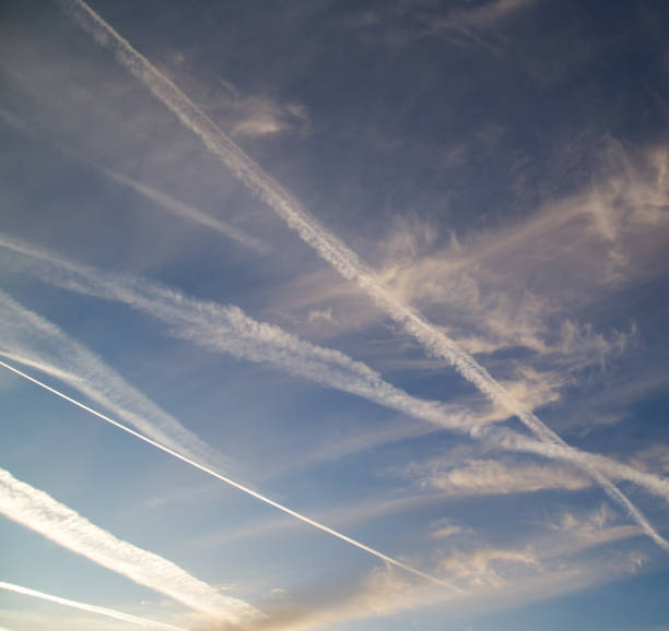istock traces of an airplane at sunset as background 883207922