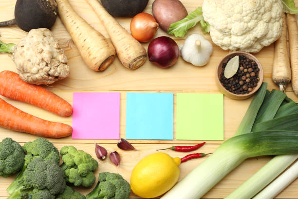 istock Fresh vegetables on light wooden background. Mockup for menu or recipe. Top view with copy space 883210360
