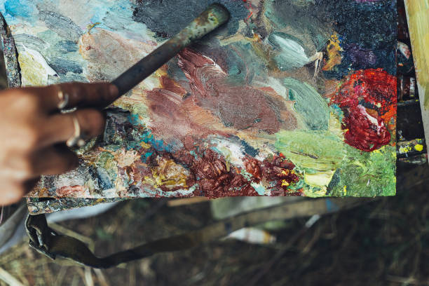 istock Artist hand paintbrush and palette 883212068