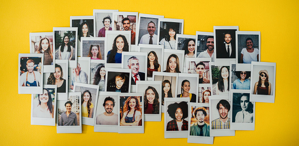 Polaroid photos of different people hanged on the wall.