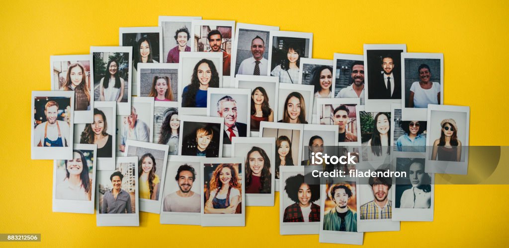 Human resources Polaroid photos of different people hanged on the wall. Instant Print Transfer Stock Photo