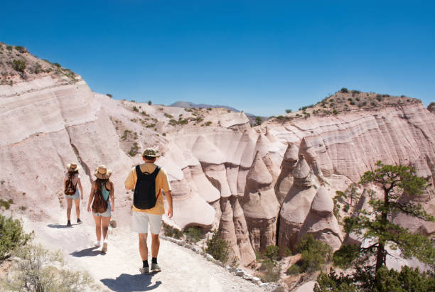 Family on hiking trip in beautiful mountains. Family on hiking trip in beautiful mountains. Kasha-Katuwe Tent Rocks National Monument, Close to of Santa Fe, New Mexico, USA kasha katuwe tent rocks stock pictures, royalty-free photos & images