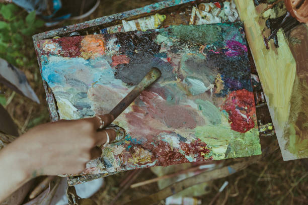 istock Artist hand paintbrush and palette, top view 883217598