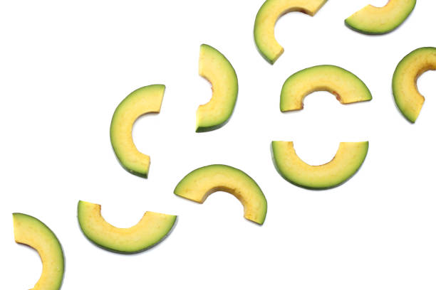 istock healthy food. sliced avocado isolated on white background. top view 883218464