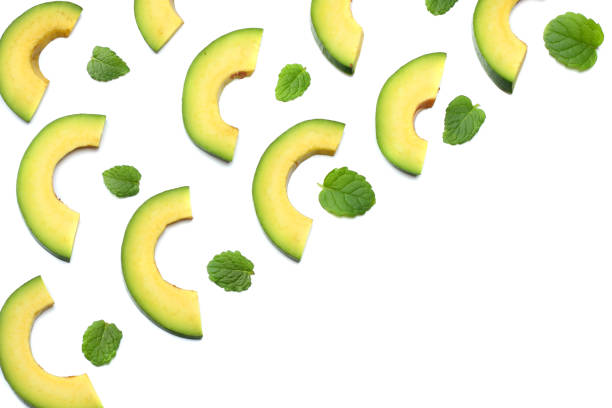 istock healthy food. sliced avocado isolated on white background. top view 883219042