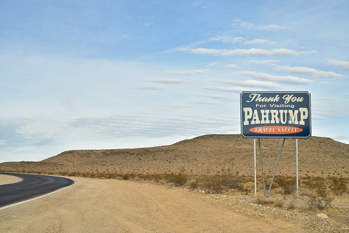 On the outskirts of the town of Pahrump, Nevada stand road signs welcoming visitors and thanking vistors