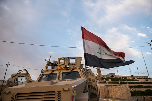Mosul, Iraq - May 23, 2017: In the Iraqi city of Mosul, an Iraqi army Mine-Resistant Ambush Protected (MRAP) vehicle is parked at the entrance to the shrine of Nabi Yunus, which was destroyed by ISIS in 2014.