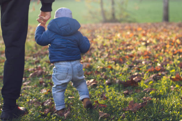 istock First baby steps in the park 883254490