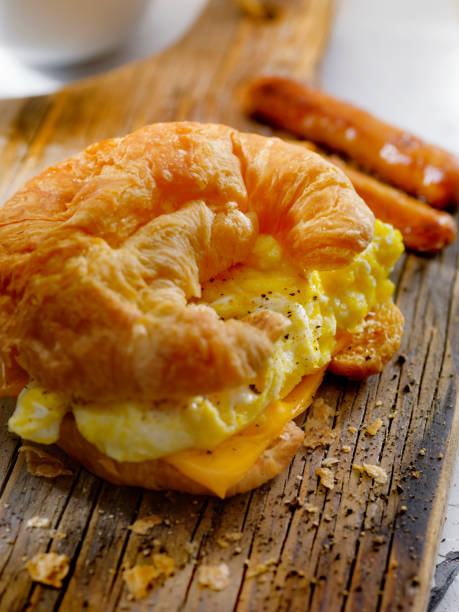 istock Egg and Cheese Breakfast Croissant with Sausages 883264938