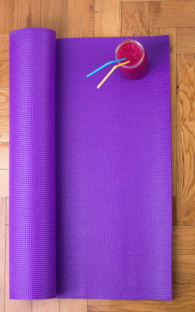 istock Yoga mat and smoothie on floor 883270944