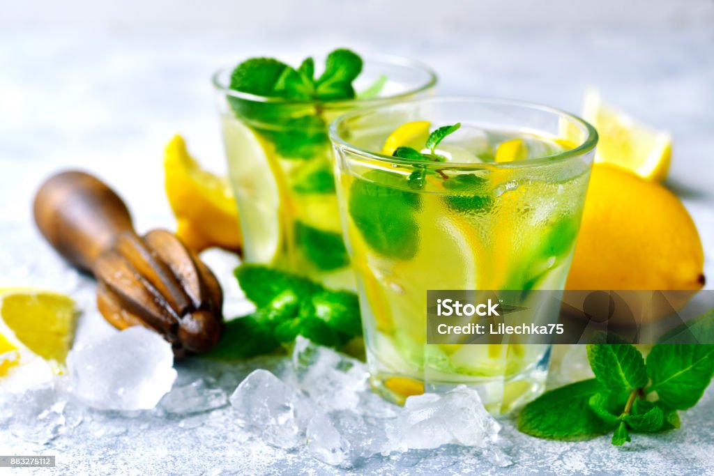 Homemdae summer lemonade Homemdae summer lemonade in a glasses on a light slate,stone or concrete background Alcohol - Drink Stock Photo