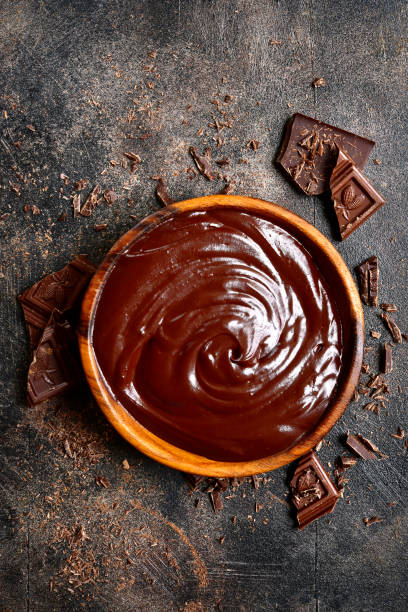 istock Chocolate ganache in a wooden bowl 883275680