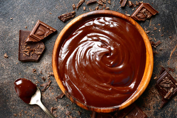 istock Chocolate ganache in a wooden bowl 883275822