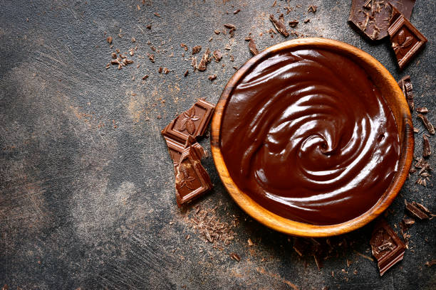 istock Chocolate ganache in a wooden bowl 883275828