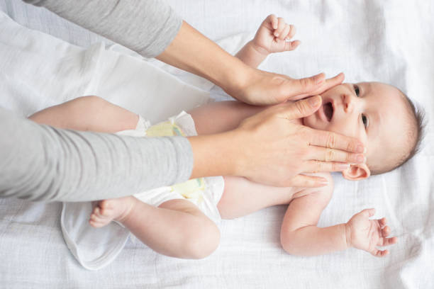 istock Mother happily playing with her baby 883296042