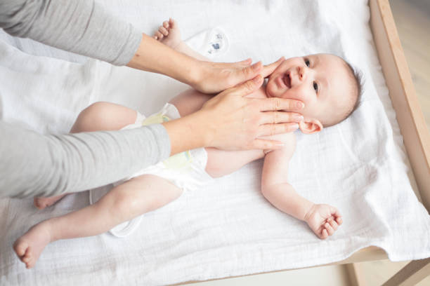istock Mother happily playing with her baby 883296052