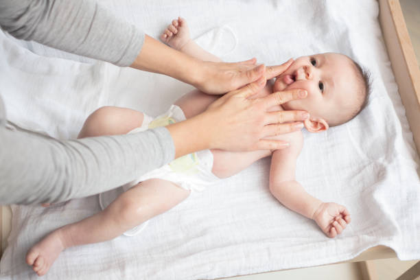 istock Mother happily playing with her baby 883296634