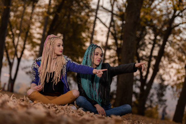 istock Two friends with African braids 883297376