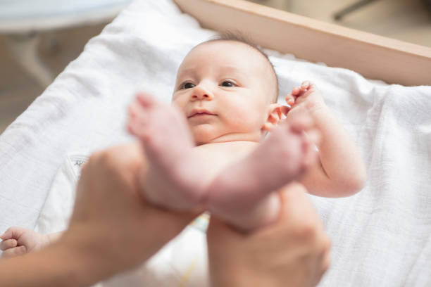 istock Mother happily playing with her baby 883297408