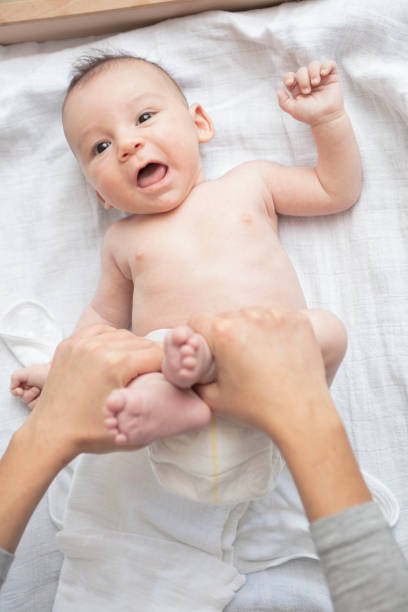 istock Mother happily playing with her baby 883297820
