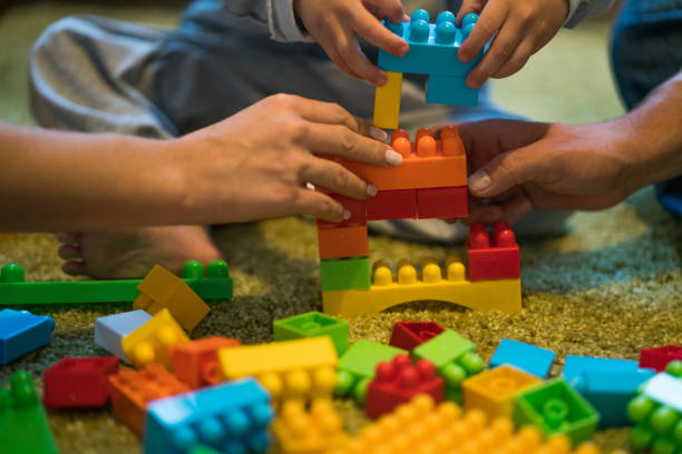 istock Family together playing with plastic blocks 883308340