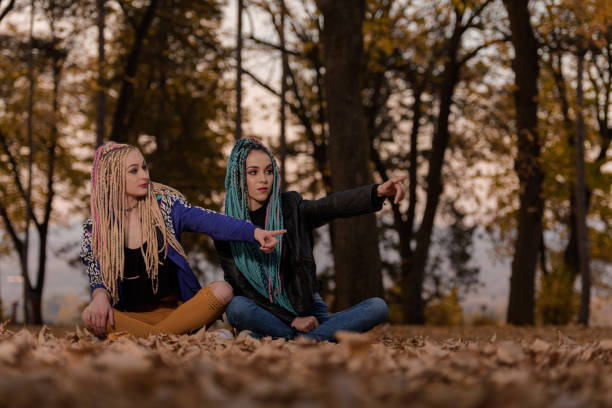 istock Two friends with African braids 883311502