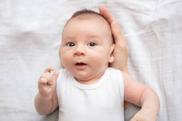 istock Mother happily playing with her baby 883311728