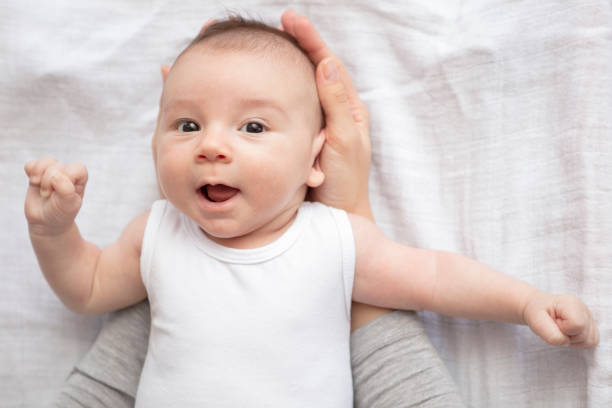 istock Mother happily playing with her baby 883312034