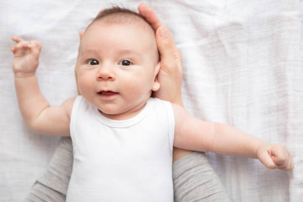 istock Mother happily playing with her baby 883312482