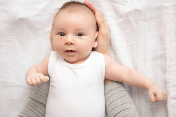 istock Mother happily playing with her baby 883312500