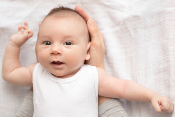 istock Mother happily playing with her baby 883312508