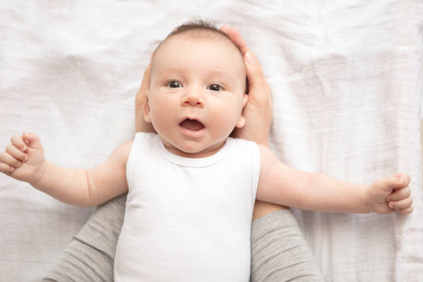 istock Mother happily playing with her baby 883313040