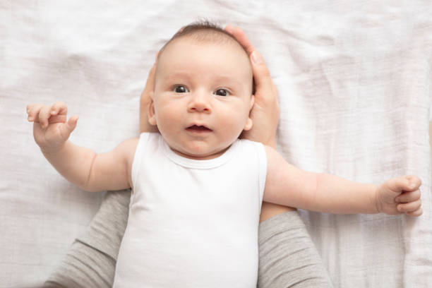 istock Mother happily playing with her baby 883313440