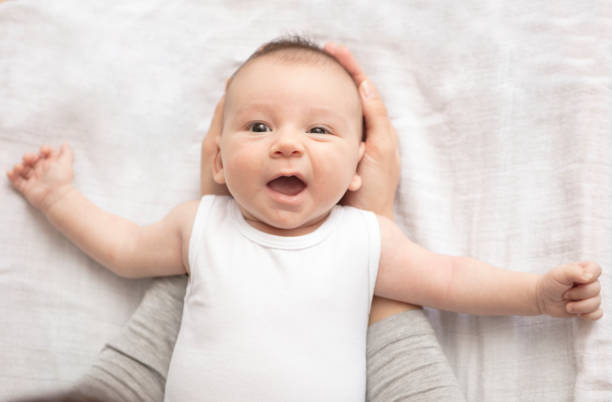 istock Mother happily playing with her baby 883313642