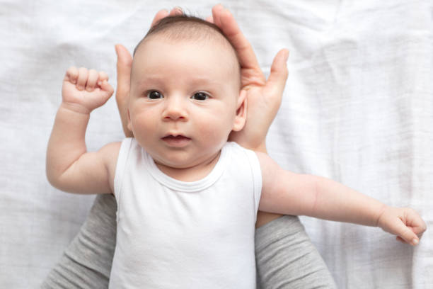 istock Mother happily playing with her baby 883316114