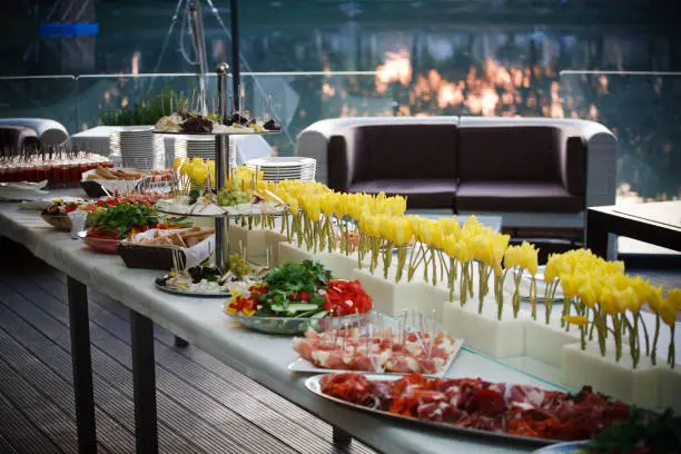 Buffet served table with snacks,fruits,canape,sweets and appetizers.Catering event plate service.Smorgasbord,food choice of breakfast in a restaurant