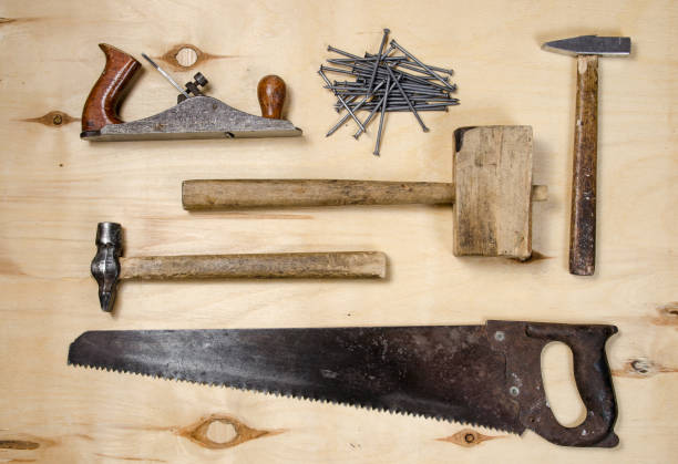 istock a set of tools for working on a timber - saw, plane, hammers, mallet, nails - lay on a sheet of plywood. flat view. 883336080