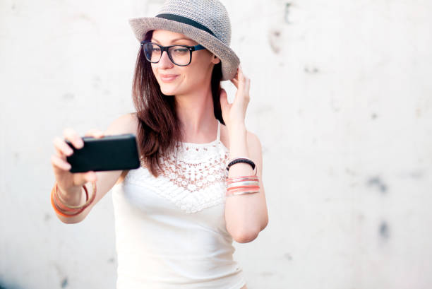 Young trendy fashionable girl taking a selfie for instagram Young trendy fashionable girl taking a selfie for instagram clubwear stock pictures, royalty-free photos & images