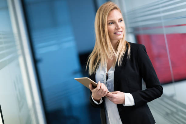 istock Beautiful businesswoman using digital tablet in office 883350696