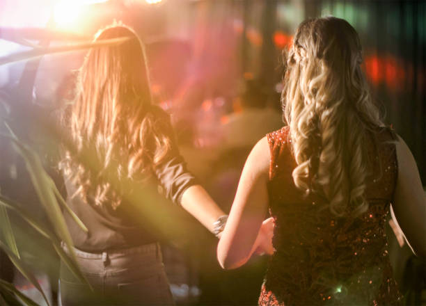 istock Friends dancing in night club 883351124