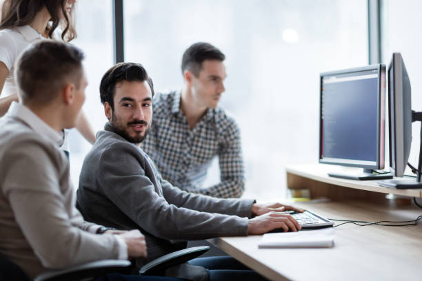 istock Picture of businesspeople working on computer together 883351376