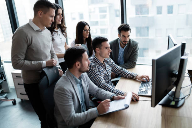 istock Picture of businesspeople working on computer together 883353300