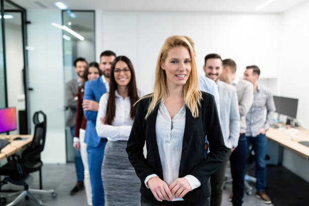 istock Group picture of business team posing in office 883357878
