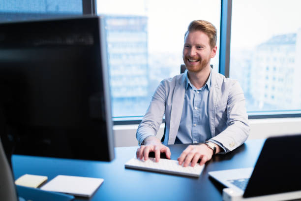 istock Portrait of young businessman working on computer 883362798