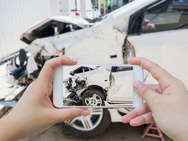 istock taking photo of the car crash accident damage 883364346