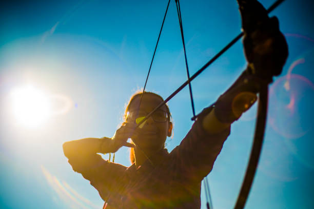 The teenager girl practicing archery in the meadows, Poconos region, Pennsylvania, USA