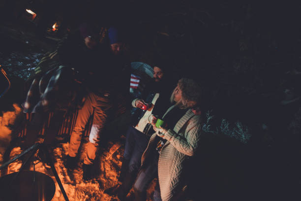 Hipster people camping on snowy mountain