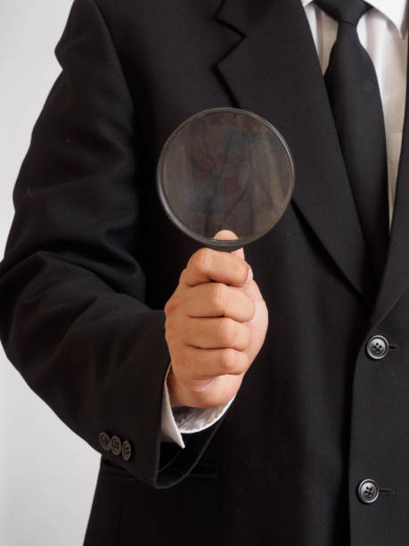 istock male hand holding plastic magnifying glass 883375320