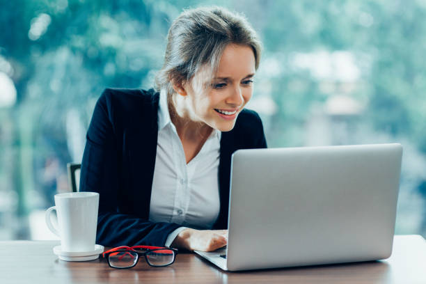 istock Young Smiling Businesswoman Working on Laptop 883383952