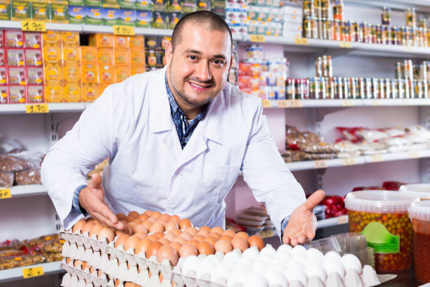 istock Man selling eggs in marketplace 883384108